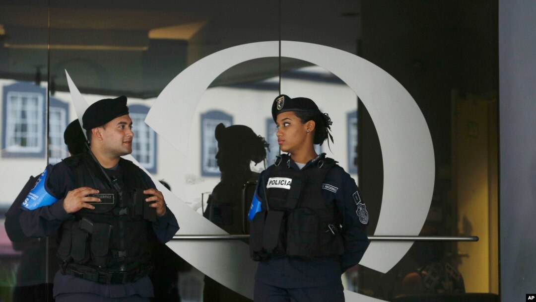 Two police officers stand outside of the Balboa Bank & Trust Corp. building in Panama City, Thursday, May 5, 2016. 