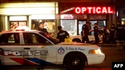 Police officers walk the scene at Danforth St. at the scene of a shooting incident, in Toronto, Canada, July 22, 2018.