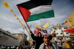 FILE - Supporters of the Palestinian Fatah movement take part in a rally marking the 55th foundation anniversary of the political party, in Gaza City, Jan. 1, 2020.