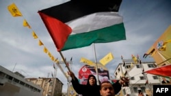 Supporters of the Palestinian Fatah movement take part in a rally marking the 55th foundation anniversary of the political party, in Gaza City, Jan. 1, 2020. 