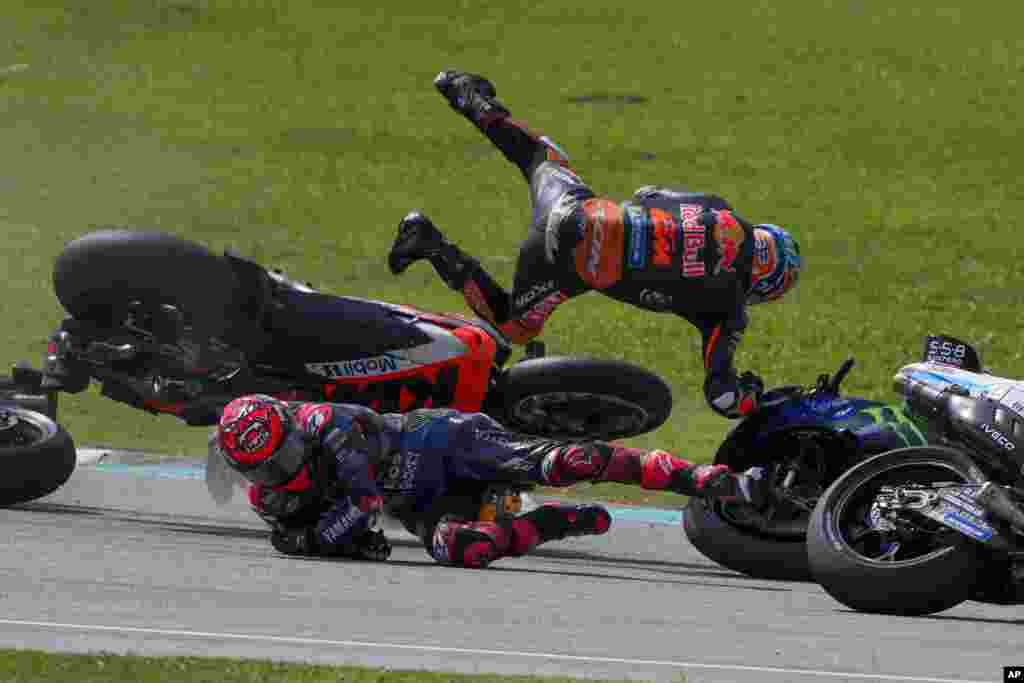 South African rider Brad Binder of&nbsp;Red Bull KTM Factory Racing, top, leaps in the air after crashing with French rider Fabio Quartararo of&nbsp;Monster Energy Yamaha during the start of the MotoGP race in Sepang, outskirts of Kuala Lumpur, Malaysia.