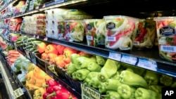 FILE - Vegetables are displayed in a produce section at a supermarket in New York, May 17, 2021. 