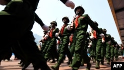 FILE - Soldiers from the rebel United Wa State Army march in the Wa State, in Panghsang, April 17, 2019. Four men were arrested in New York on April 4 and 5, 2022, for working to acquire missiles for United Wa State Army and other rebel groups.
