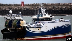 FILE - A French fishing boat blocks the entrance to the port of Calais, northern France, Nov. 26, 2021.