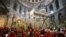 Roman Catholic clergy carry palm branches as they circle the aedicule during the Palm Sunday procession at the Church of the Holy Sepulchre in Jerusalem's Old City, Apr. 10, 2022.
