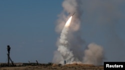 FILE - An S-300 air defense system launches a missile during exercises at the Ashuluk shooting range outside Astrakhan, Russia, Aug. 5, 2017. Slovakia on Friday announced it has transferred its S-300 air defense system to Ukraine.