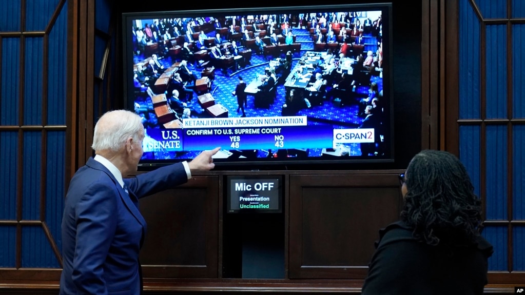 President Joe Biden and Supreme Court nominee Judge Ketanji Brown Jackson watch as the Senate votes on her confirmation from the Roosevelt Room of the White House in Washington, Thursday, April 7, 2022. (AP Photo/Susan Walsh)