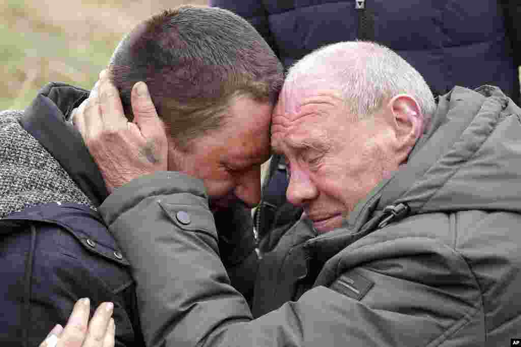 Relatives cry at the mass grave of civilians killed during Russian occupation in Bucha, on the outskirts of Kyiv, Ukraine. (AP Photo/Efrem Lukatsky)