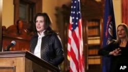 FILE - Michigan Gov. Gretchen Whitmer addresses the state during a speech in Lansing, Mich., Oct. 8, 2020.