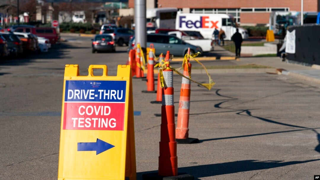 FILE - A sign points to a COVID testing site at the Cincinnati Veterans Affairs Medical Center in Cincinnati, Jan. 3, 2022. The U.S. may be heading into another COVID-19 surge, with cases rising nationally and in most states after a two-month decline.