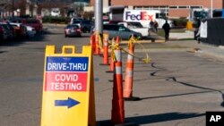 FILE - A sign points to a COVID testing site at the Cincinnati Veterans Affairs Medical Center in Cincinnati, Jan. 3, 2022. The U.S. may be heading into another COVID-19 surge, with cases rising nationally and in most states after a two-month decline.