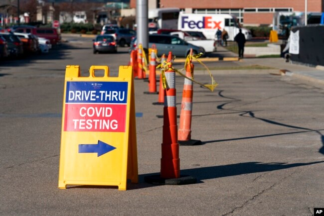 FILE - A sign points to a COVID testing site at the Cincinnati Veterans Affairs Medical Center in Cincinnati, on Jan. 3, 2022.