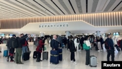 Antrean penumpang mengantre untuk pemeriksaan keamanan di area keberangkatan Terminal 2 di Bandara Manchester di Manchester, Inggris, 4 April 2022. (REUTERS/Phil Noble)