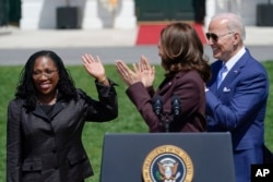 President Joe Biden and Vice President Kamala Harris applaud Judge Ketanji Brown Jackson as Harris speaks during an event on the South Lawn of the White House in Washington, April 8, 2022.