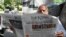 A man reads a newspaper in Islamabad on April 8, 2022, after Pakistan's Supreme Court ruled that the National Assembly must reconvene to hold a no-confidence vote on Prime Minister Imran Khan.