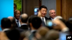 From left, S. African President Jacob Zuma, Chinese President Xi Jinping, and Brazilian President Michel Temer arrive for the opening ceremony of the BRICS Business Forum at the Xiamen International Conference and Exhibition Center in Xiamen, China, Sept.