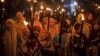 FILE - Muslim girls carry torches during a parade to celebrate the eve of Eid al-Fitr, the holiday marking the end of the holy fasting month of Ramadan, in Polewali Mandar, West Sulawesi, Indonesia, April 21, 2023.