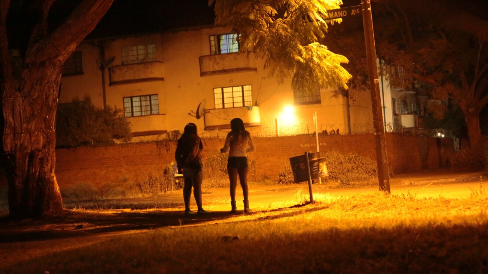 Sex workers wait for clients in the red light district of Harare, Zimbabwe, June 12, 2020. As the coronavirus spreads in Africa, it increasingly threatens those who earn their living on the streets, including sex workers with HIV.