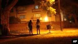 Sex workers wait for clients in the red light district of Harare, Zimbabwe, June 12, 2020. As the coronavirus spreads in Africa, it increasingly threatens those who earn their living on the streets, including sex workers with HIV.