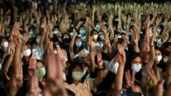 Pro-democracy students raise a three-finger salute, a resistance symbol borrowed by Thailand's anti-coup movement from the movie "The Hunger Games," during a protest at Thammasat University near Bangkok, Thailand, Aug, 10, 2020.