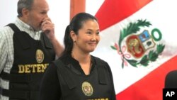 FILE - Keiko Fujimori, the daughter of Peru's former President Alberto Fujimori, and leader of the opposition party, enters to the courtroom wearing a chest vest that reads in Spanish: "Detained" in Lima, Peru, Oct. 17, 2018.