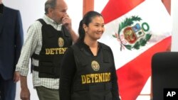 FILE - Keiko Fujimori, the daughter of Peru's former President Alberto Fujimori, and leader of the opposition party, enters to the courtroom wearing a chest vest that reads in Spanish: "Detained" in Lima, Peru, Oct. 17, 2018.
