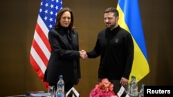 FILE - U.S. Vice President Kamala Harris, left, shakes hands with President Volodymyr Zelenskyy of Ukraine as they meet during the Ukraine peace summit, in Stansstad near Lucerne, Switzerland, June 15, 2024.