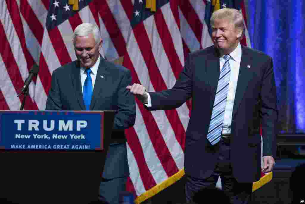 Republican presidential candidate Donald Trump, right, introduces Gov. Mike Pence, R-Ind., during a campaign event to announce Pence as the vice presidential running mate in New York, July 16, 2016.
