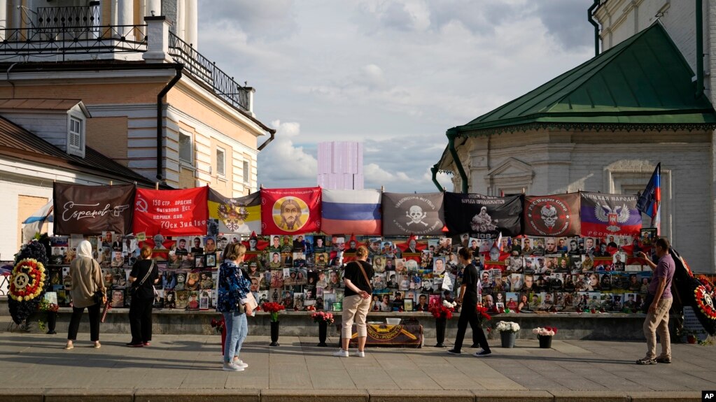 People stand near a memorial to Russian mercenary chief Yevgeny Prigozhin, who died in a plane crash last year, in Moscow on July 29, 2024. Prigozhin's Wagner unit suffered heavy losses in an attack in Mali last week.