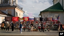 People stand near a memorial to Russian mercenary chief Yevgeny Prigozhin, who died in a plane crash last year, in Moscow on July 29, 2024. Prigozhin's Wagner unit suffered heavy losses in an attack in Mali last week.