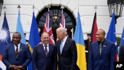 President Joe Biden talks with Cook Islands Prime Minister Mark Brown, second from left, with Pacific Islands Forum leaders in Washington, Sept. 25, 2023. Papua New Guinean Prime Minister James Marape, left, and Kiribati's President Taneti Maamau, right, look on. 