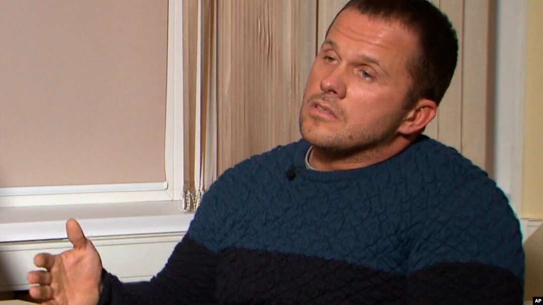 FILE - A video grab provided by Russia's RT channel Sept. 13, 2018 shows a man identified as Alexander Petrov during an interview in Moscow, Russia. Investigative group Bellingcat reported Oct. 8, 2018 on its website that the man British authorities identified as Alexander Petrov is actually Alexander Mishkin, a doctor working for the Russian military intelligence service known as GRU.