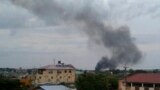 FILE - Black smoke is seen rising above the capital Juba, in South Sudan, July 10, 2016. 