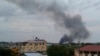 In this photo taken Sunday, July 10, 2016, black smoke is seen rising above the capital Juba, in South Sudan. 