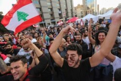Protesters celebrate after Lebanon's Prime Minister Saad al-Hariri announced his resignation in Beirut, Lebanon, Oct. 29, 2019.