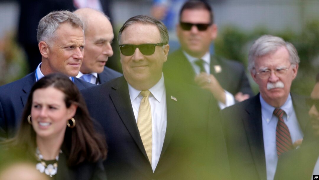 Secretary of State Mike Pompeo, center, and U.S. National security adviser John Bolton, right, arrive for a summit of heads of state and government at NATO headquarters in Brussels, July 11, 2018.