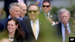 Secretary of State Mike Pompeo, center, and U.S. National security adviser John Bolton, right, arrive for a summit of heads of state and government at NATO headquarters in Brussels, July 11, 2018.