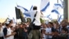 FILE - Israelis nationalists wave national flags during a Jerusalem Day march, in Jerusalem, May 10, 2021. 