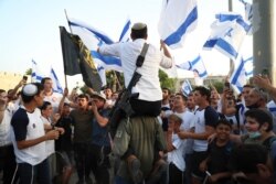Israelis nationalists wave national flags during a Jerusalem Day march, in Jerusalem, Monday, May 10, 2021.