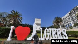 FILE: An Algerian worker cleans the "Jardin Horloge Florate" on October 31, 2022, in the center of the capital, Algiers.