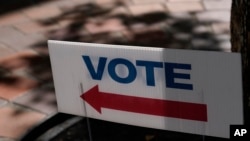 FILE - A sign stands outside an early voting location in Miami, Florida, Oct. 31, 2022. U.S. midterm elections have been closely followed overseas — especially in Europe, where analysts say some of America’s closest and oldest allies are relieved U.S. democracy held the course. 