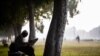 FILE - A man reads a newspaper while sitting on a bench at a park in New Delhi on Nov. 18, 2020. Media group Report for the World helps support newsrooms around the globe by training and supporting journalists in underrepresented communities. (Jewel Samad/AFP)