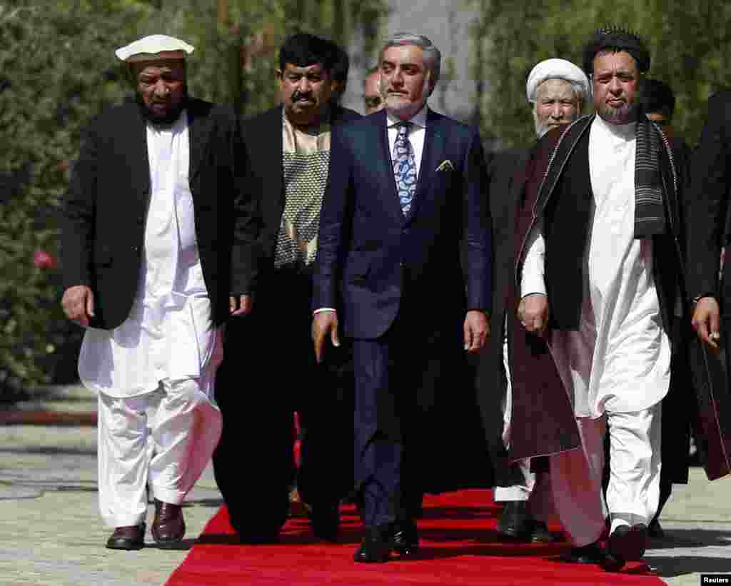 Abdullah Abdullah, center, arrives for his inauguration as chief executive in Kabul, Sept. 29, 2014.