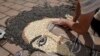 Kosovo artist Alkent Pozhegu works on a mosaic made of grains showing a portrait of Michael Jackson, in Gjakova