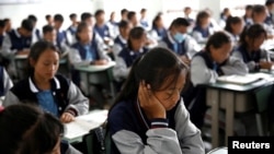 FILE - Students attend a class at the Wenchang Middle School in Yuexi during a government-organized media tour in Liangshan Yi Autonomous Prefecture, Sichuan province, China, September, 11, 2020. 