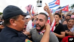 Miami Police Chief Art Acevedo, left, hugs a demonstrator, July 14, 2021, in Miami's Little Havana neighborhood, as people rallied in support of antigovernment demonstrations in Cuba.