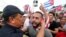 Miami Police Chief Art Acevedo, left, hugs a demonstrator, July 14, 2021, in Miami's Little Havana neighborhood, as people rallied in support of antigovernment demonstrations in Cuba.