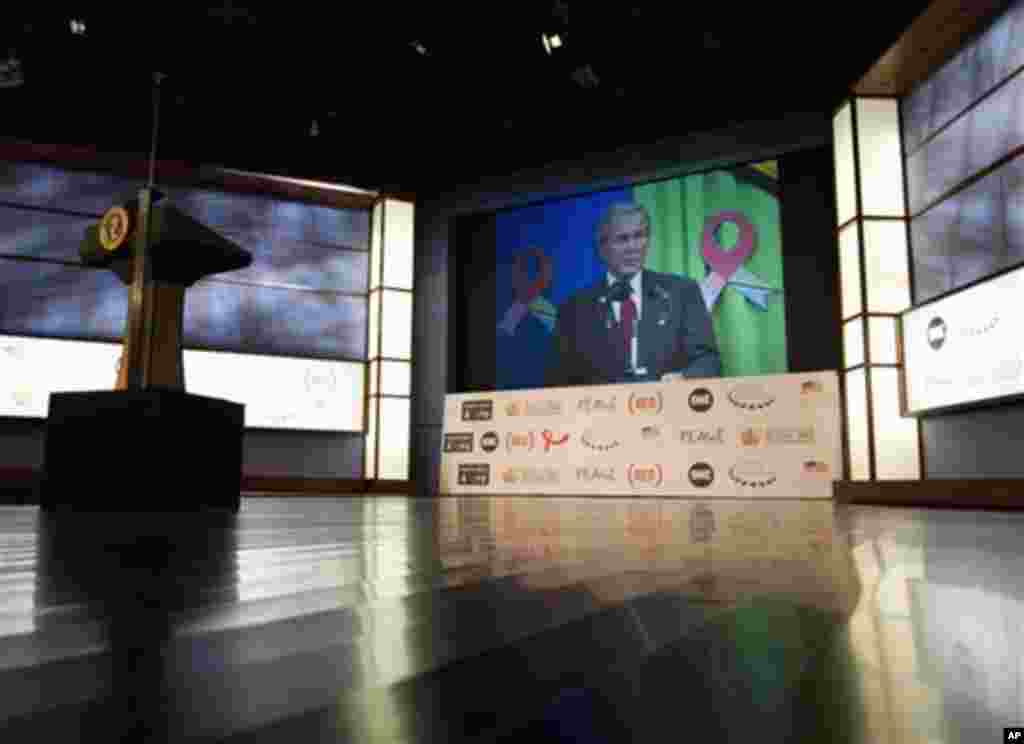 Former President George W. Bush is seen an a large video screen as he speaks to the audience via satellite from Tanzania during a World AIDS Day event at George Washington University in Washington, Thursday, Dec. 1, 2011. (AP Photo/Carolyn Kaster)