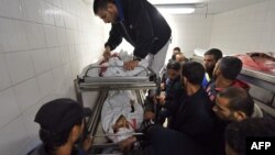 Palestinians gather at a hospital morgue in Khan Younis where the bodies of four of the six men killed during an Israeli raid on the city have been transported, Nov. 11, 2018.