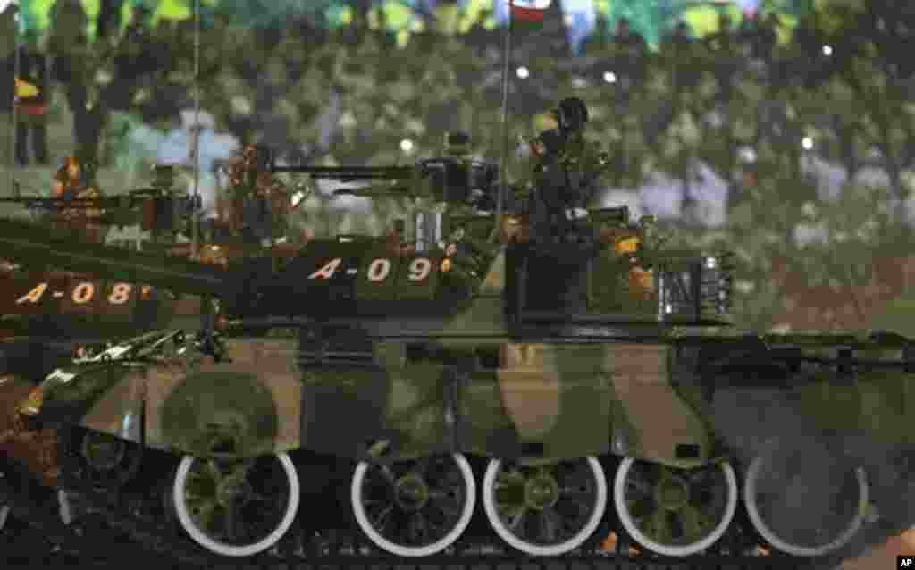 Military tanks are driven in a parade during a ceremony to mark Myanmar's 67th anniversary of Independence Day in Naypyitaw, Myanmar, Sunday, Jan. 4, 2015. (AP Photo/Gemunu Amarasinghe)